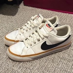 Nike White and Black Sneakers with Gold Accents